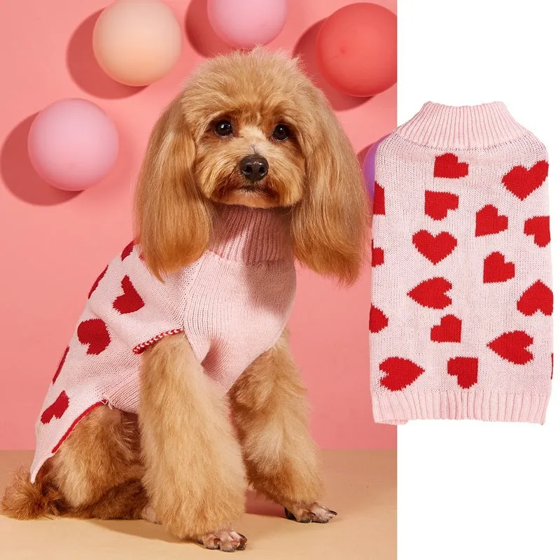 Dog wearing acrylic jumper with decorative heart or bow design in pink or red colours