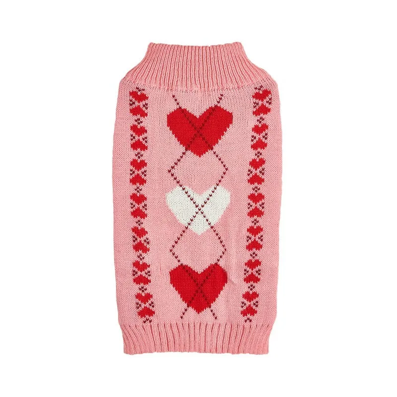 Dog wearing acrylic jumper with decorative heart or bow design in pink or red colours