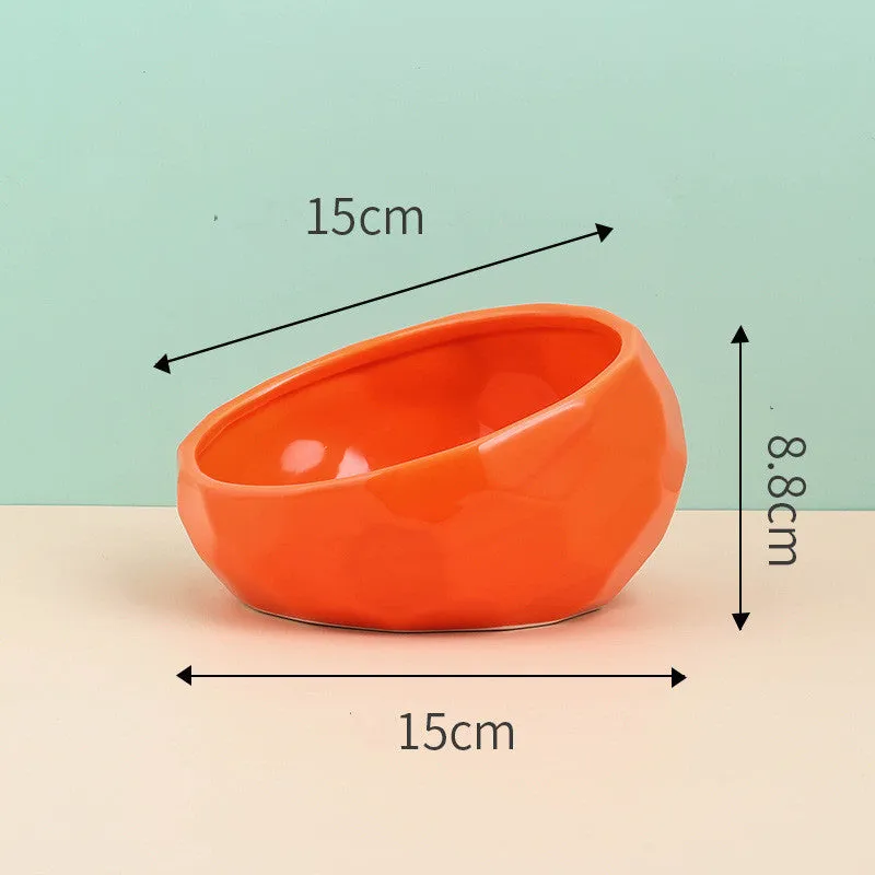 Ceramic cat bowl with oblique mouth design in white colour option on a surface