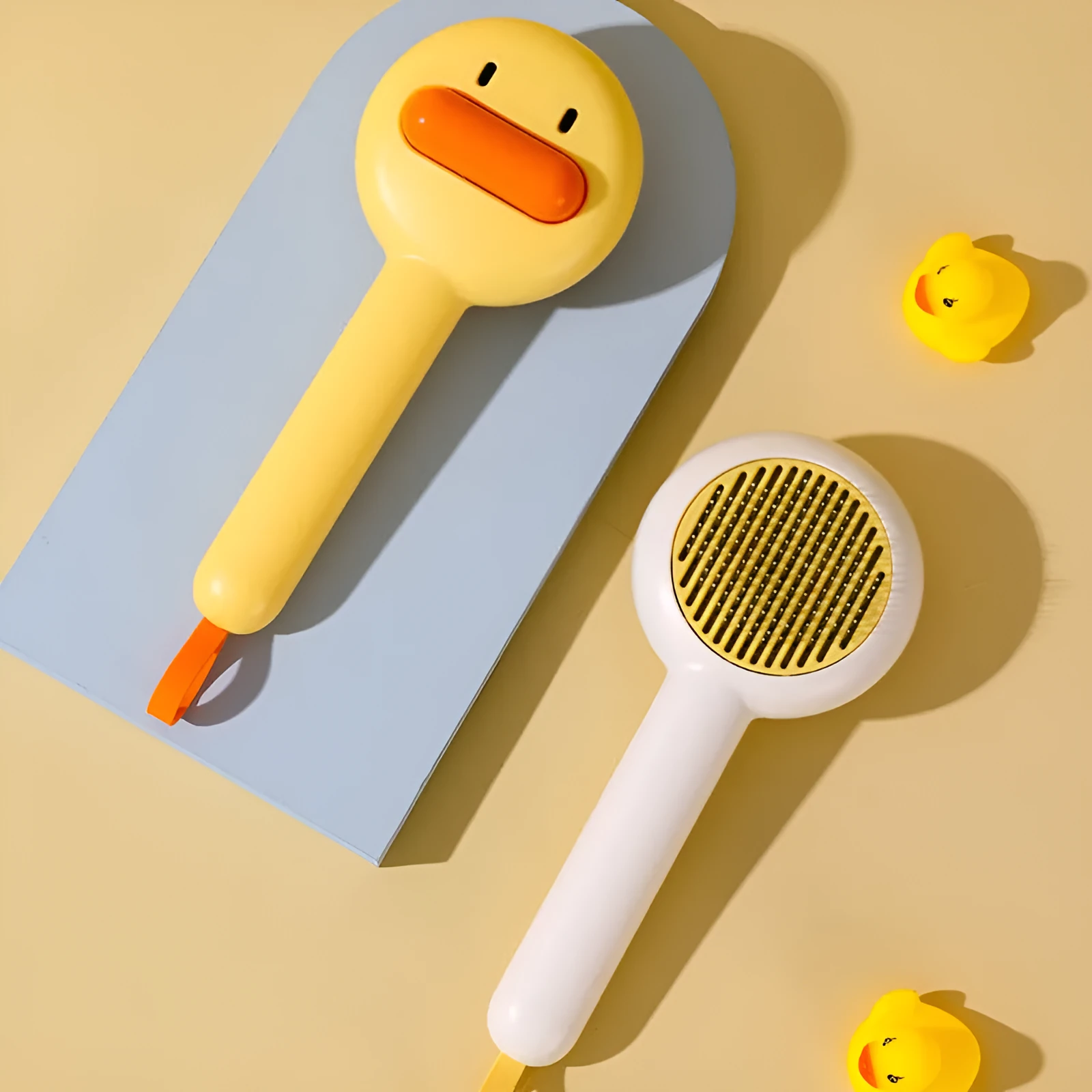 Small yellow duck comb with needle pins for pet hair removal on cats and dogs