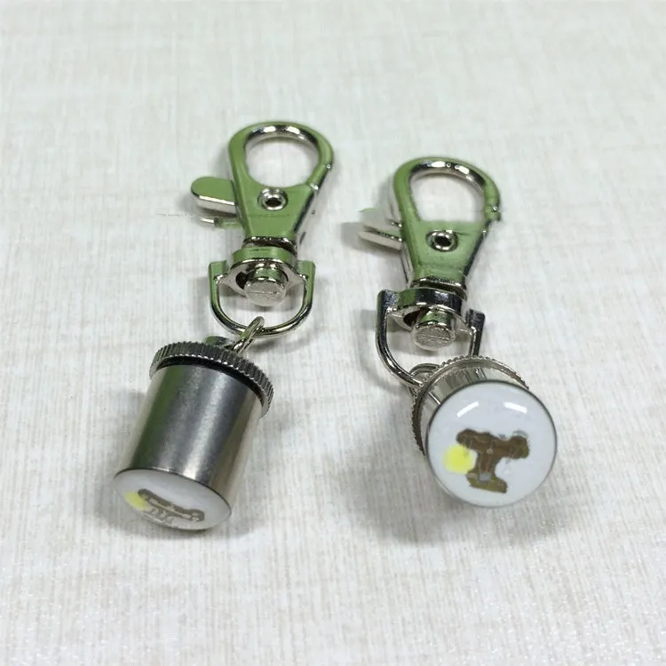 LED pet light in silver with copper alloy body showing 60mm length and 12mm width on a dog collar