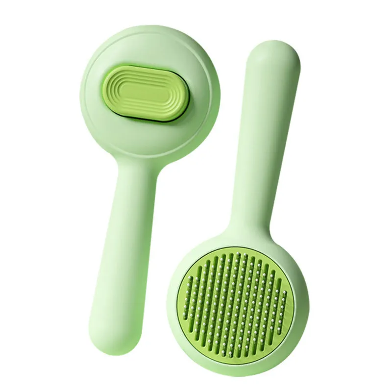 Stainless steel cat grooming brush with non-slip plastic handle in green colour
