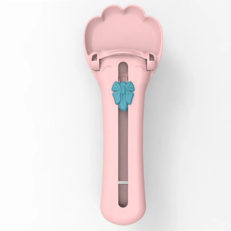 Green and pink pet food dispenser spoon with silicone squeezer tube for liquid cereal feeding