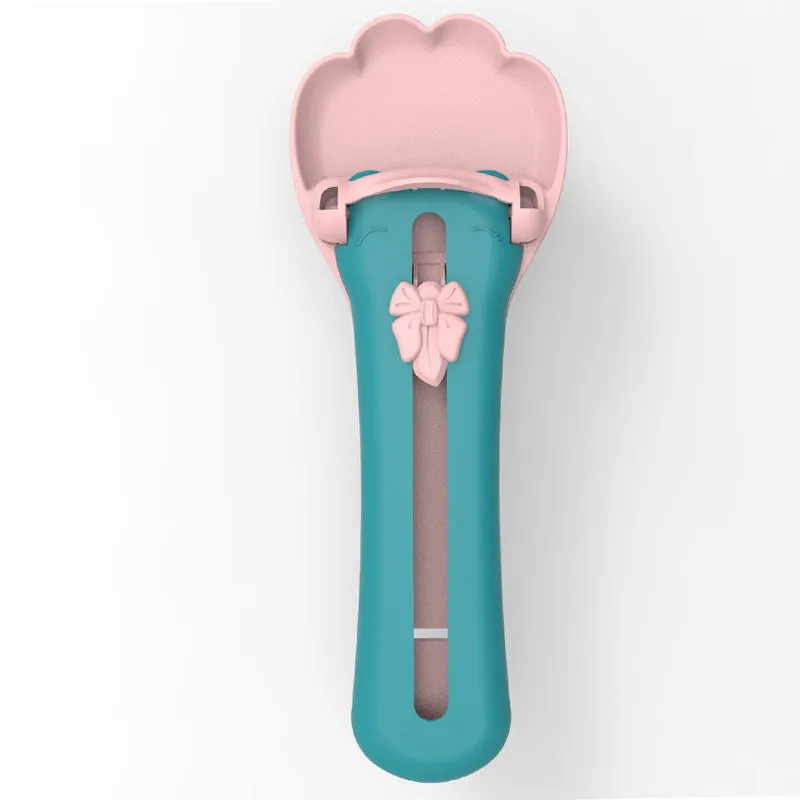 Green and pink pet food dispenser spoon with silicone squeezer tube for liquid cereal feeding