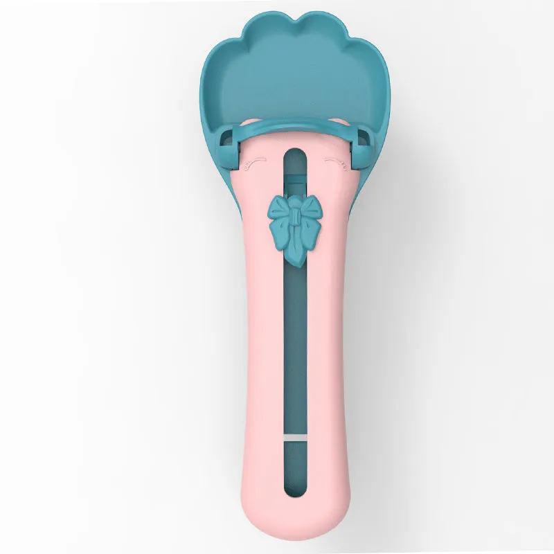 Green and pink pet food dispenser spoon with silicone squeezer tube for liquid cereal feeding