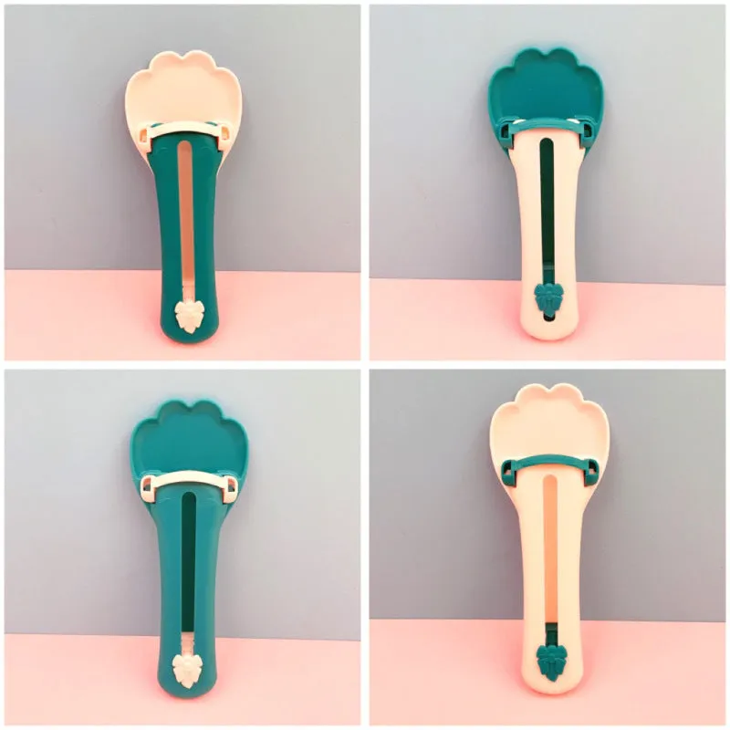 Green and pink pet food dispenser spoon with silicone squeezer tube for liquid cereal feeding