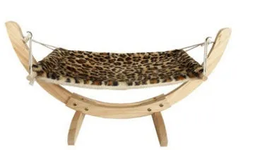 Cat hammock wooden bed with beige removable cushion on a radiator, providing a cosy perch for cats.
