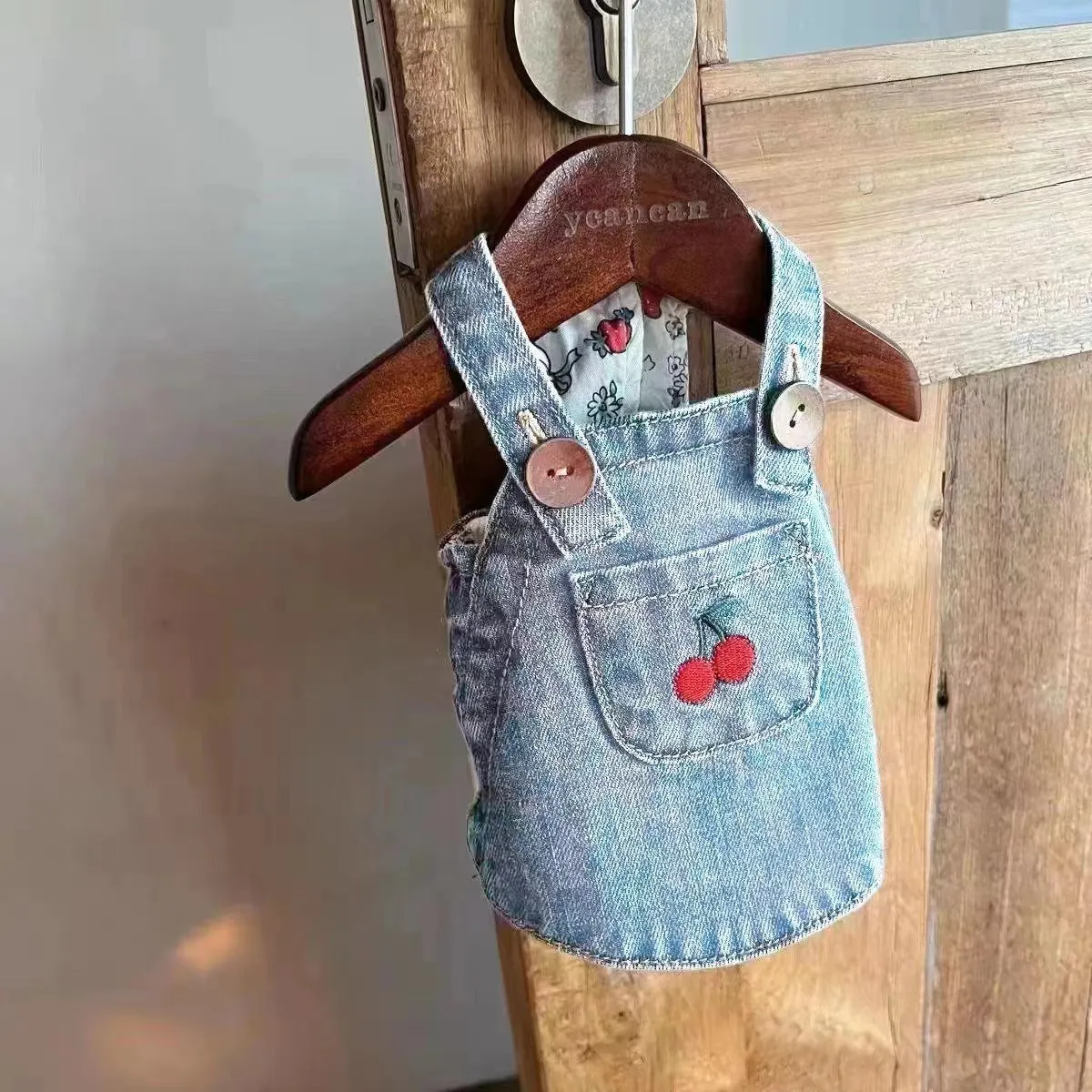 Small dog wearing a cherry dark blue denim skirt for spring summer
