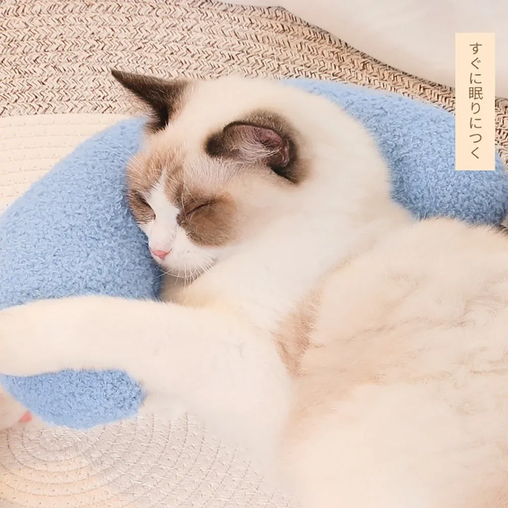 Blue U-shaped cat pillow with adjustable fabric collar on a sofa