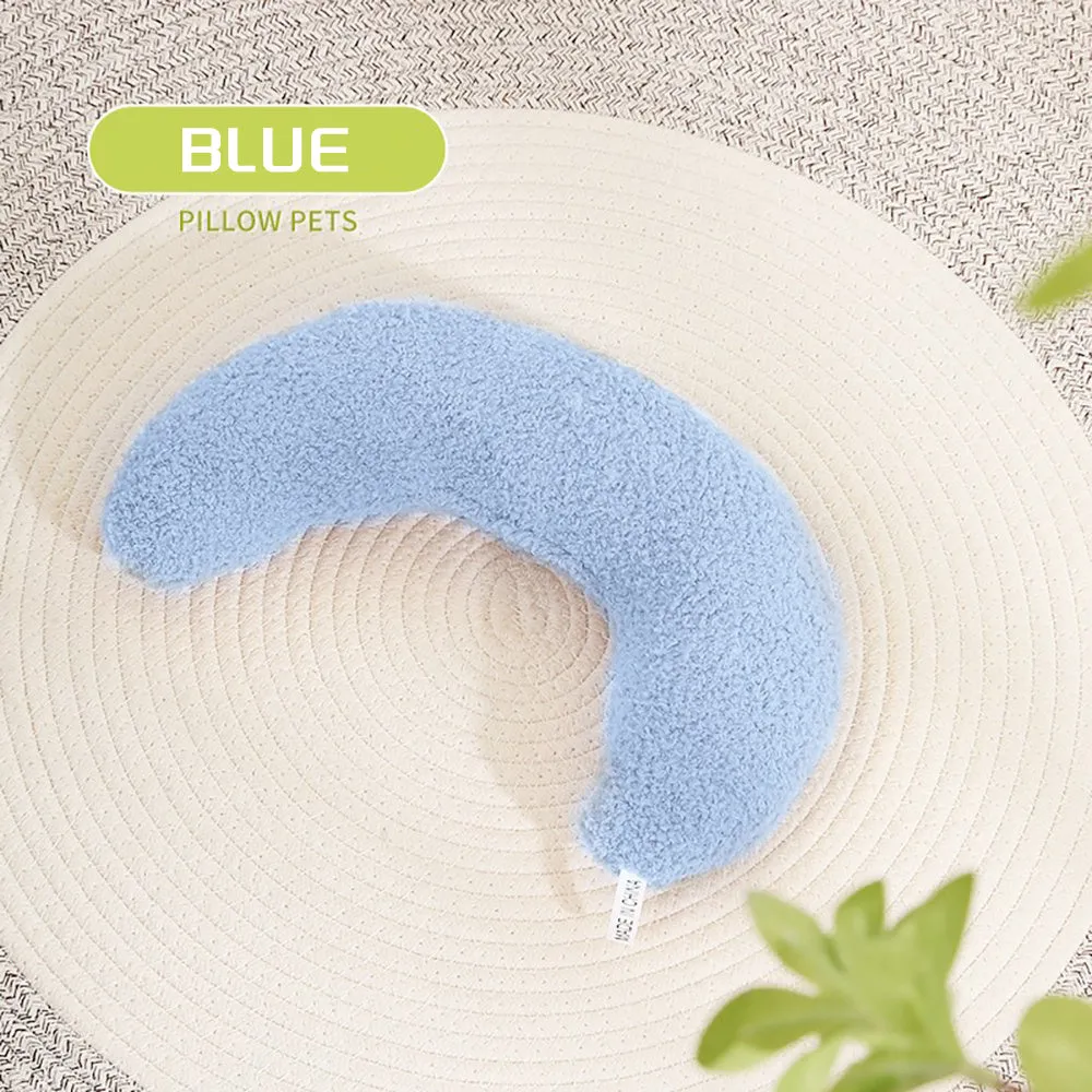 Blue U-shaped cat pillow with adjustable fabric collar on a sofa