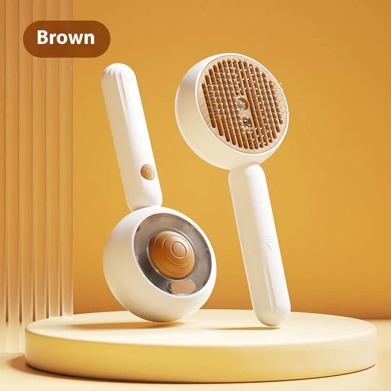 Grey and brown pet spray comb with stainless steel teeth and one-click mechanism on white background