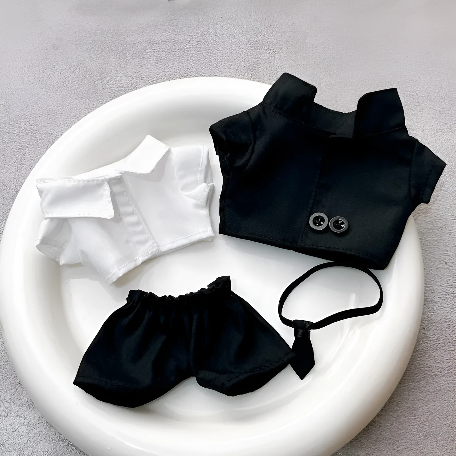 Black suit set for dolls with oval sunglasses and ankle boots, polyester material.