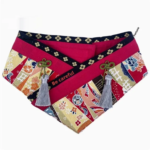 Japanese style pet scarf bib with red diamond pattern and tassels on a light background