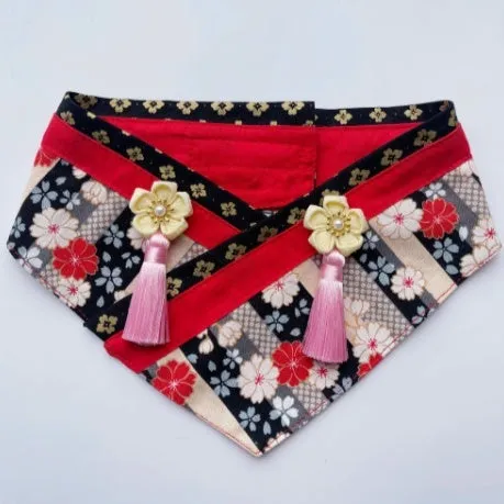 Japanese style pet scarf bib with red diamond pattern and tassels on a light background