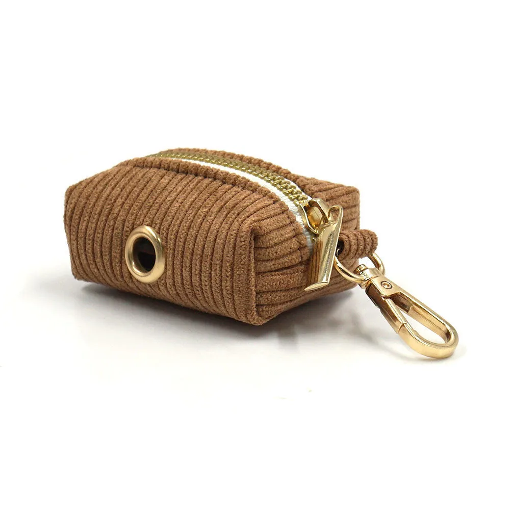 Brown corduroy dog collar and harness set with gold buckle and matching bow on a white background