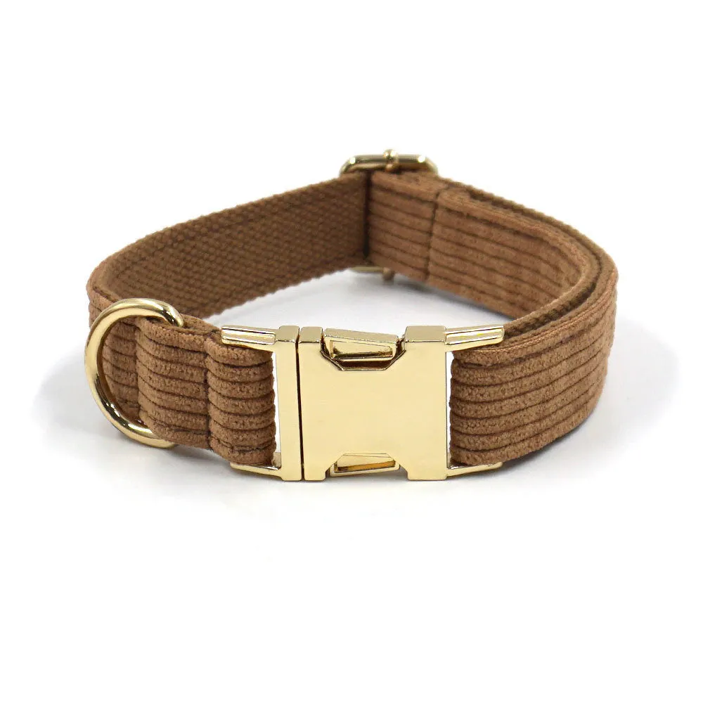 Brown corduroy dog collar and harness set with gold buckle and matching bow on a white background
