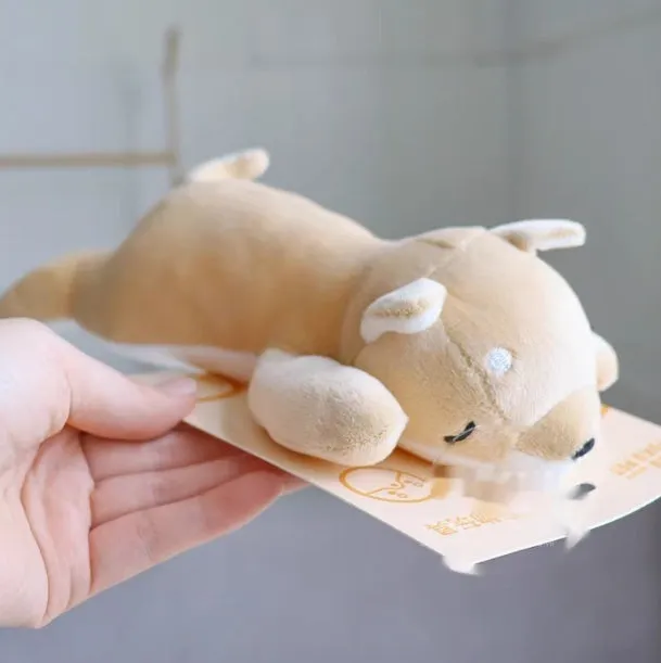 Plush dog toys in Xiaojiu butt, seal, whale, dolphin, and Shiba Inu shapes on a light background