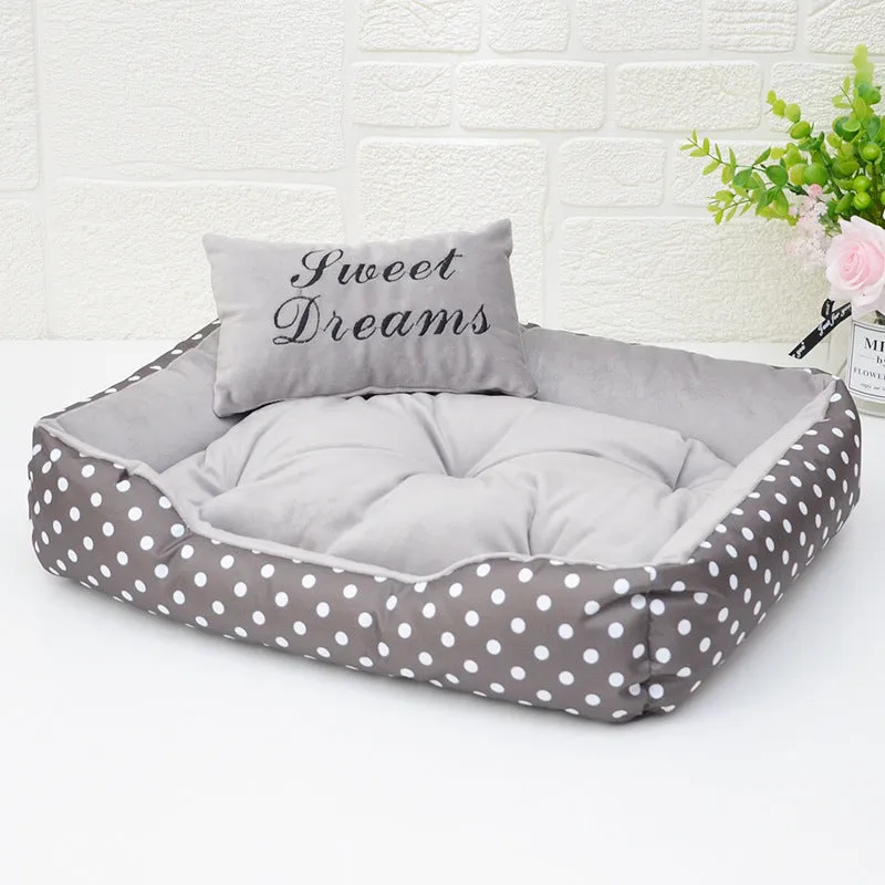 Polka dot print square nest dog bed with matching embroidered cushion in grey, blue, pink, or red.