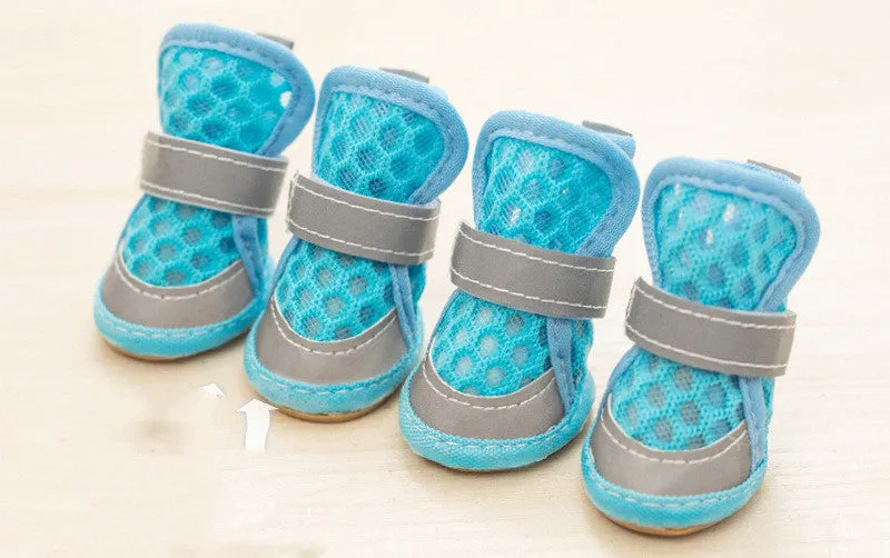 Set of four small dog rubber shoes in blue, red, orange, green for non-slip paw protection