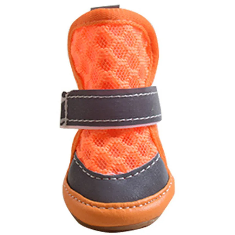 Set of four small dog rubber shoes in blue, red, orange, green for non-slip paw protection
