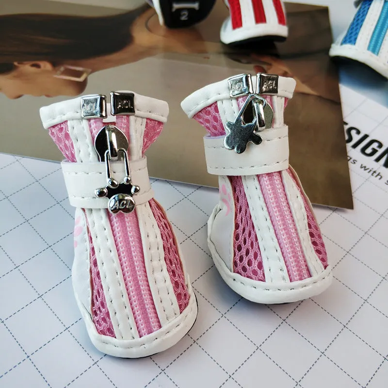 Four blue cloth dog sneakers with zipper closures arranged on a white background