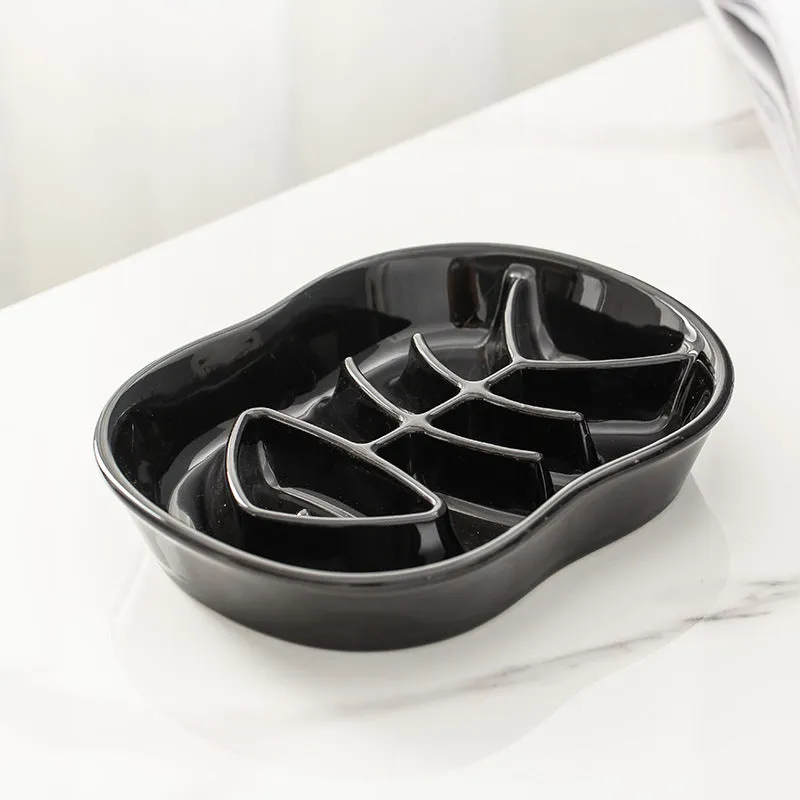 Ceramic shallow cat bowl in black on a light background, showing wide lip and low profile for whisker comfort