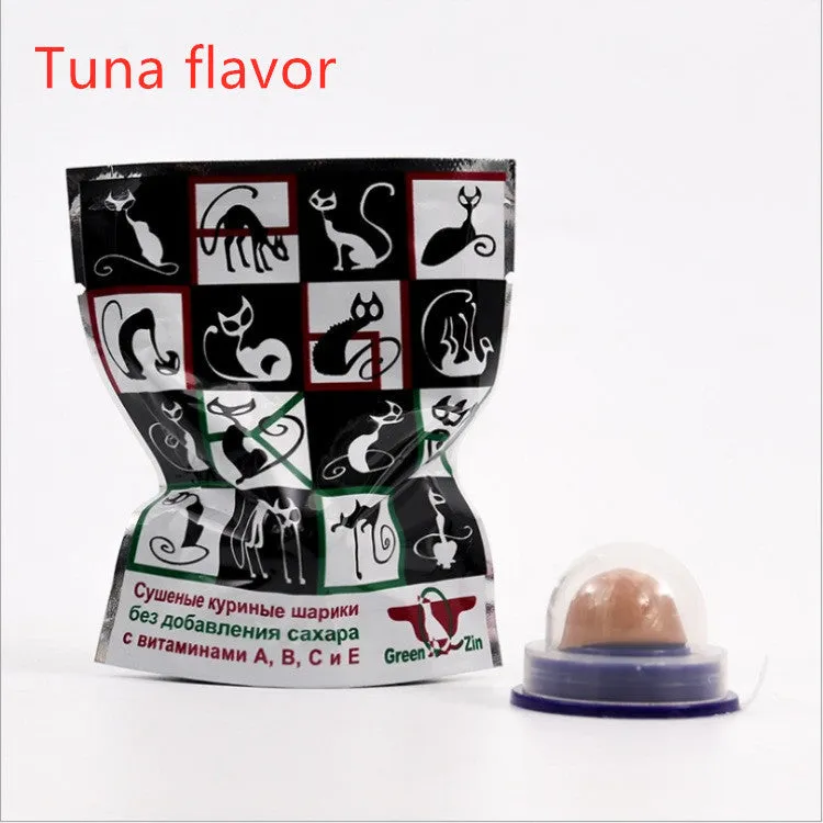 Green and blue pet cat sugar energy ball with catnip and gold fish gelatin on a floor