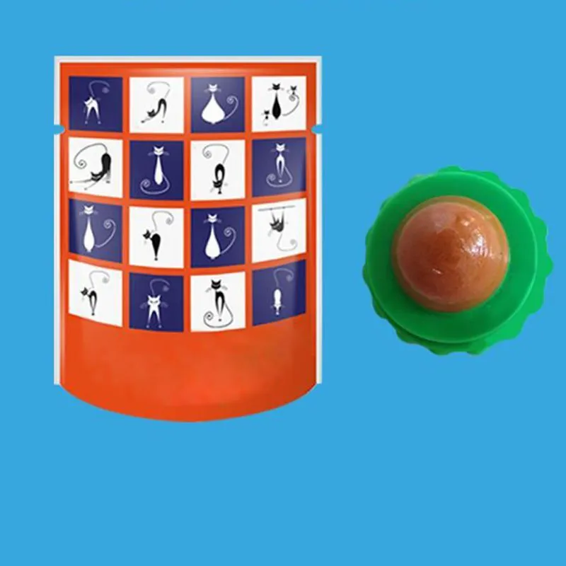 Green and blue pet cat sugar energy ball with catnip and gold fish gelatin on a floor