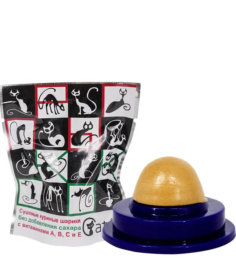 Green and blue pet cat sugar energy ball with catnip and gold fish gelatin on a floor