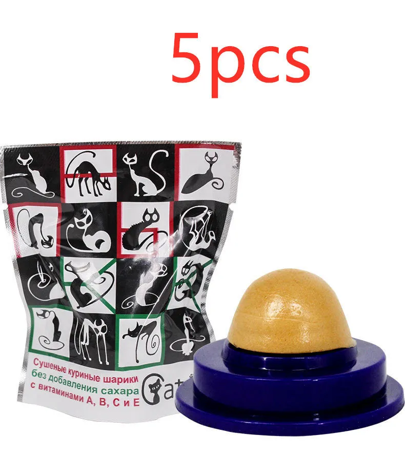 Green and blue pet cat sugar energy ball with catnip and gold fish gelatin on a floor