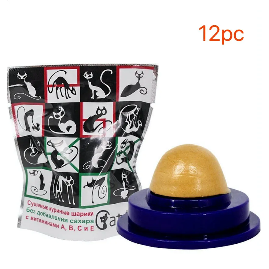 Green and blue pet cat sugar energy ball with catnip and gold fish gelatin on a floor