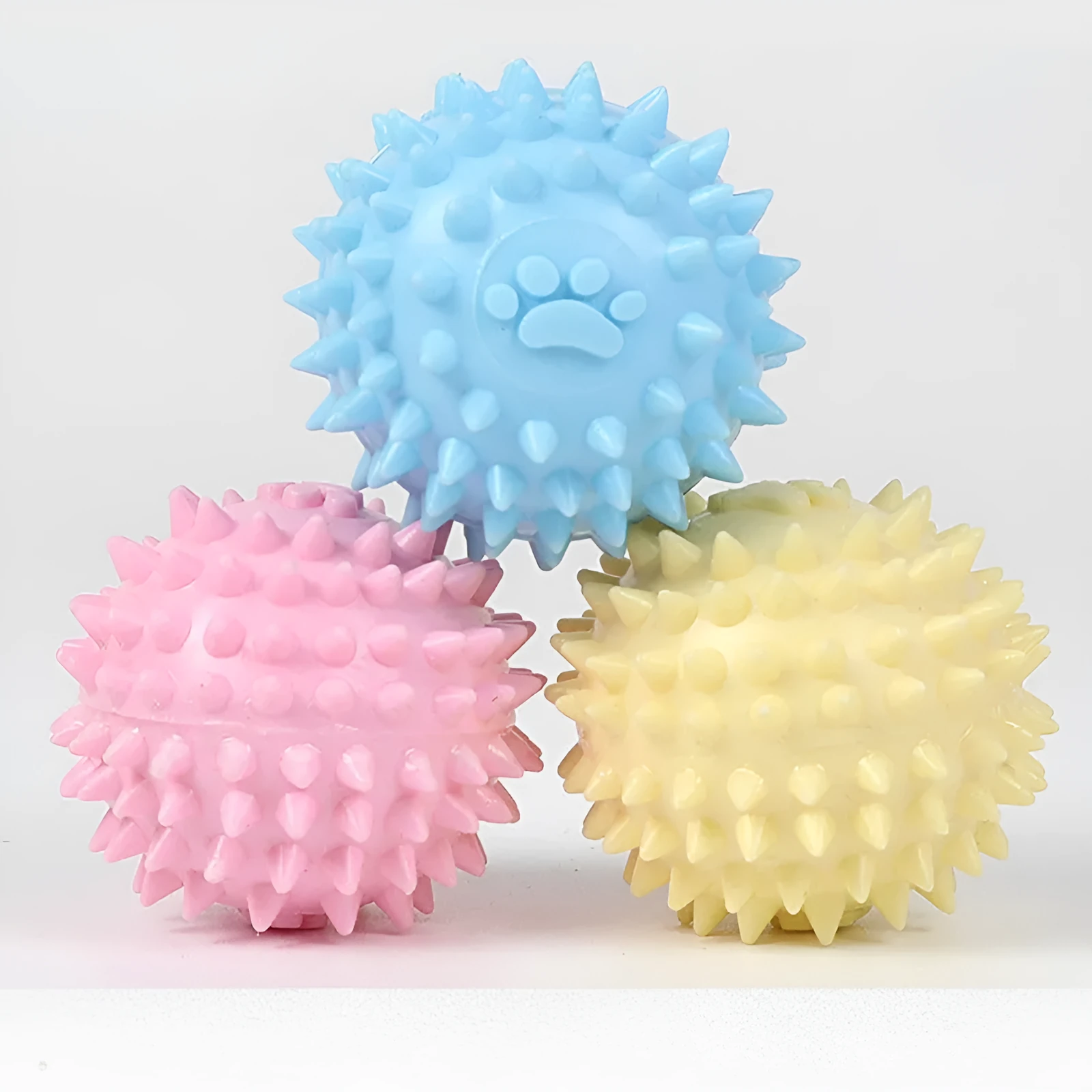 Blue TPR dog chewing ball with textured footprint design for teeth cleaning, 6cm diameter