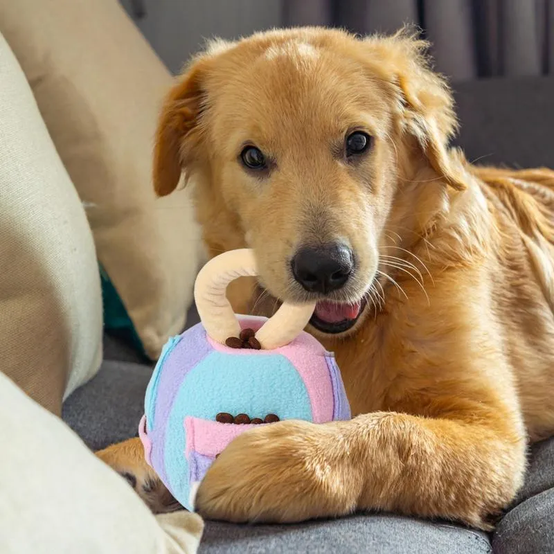 Green and pink plush squeaky ball dog toy with treat pockets on a white background