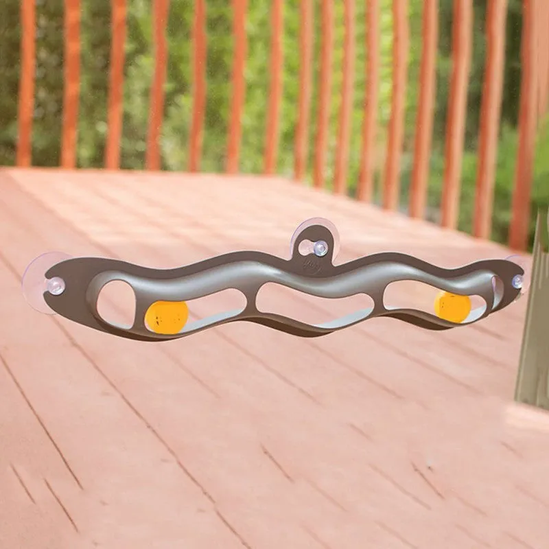 Interactive track ball cat toy with grey plastic track and suction cup attached to a window, 58 cm length