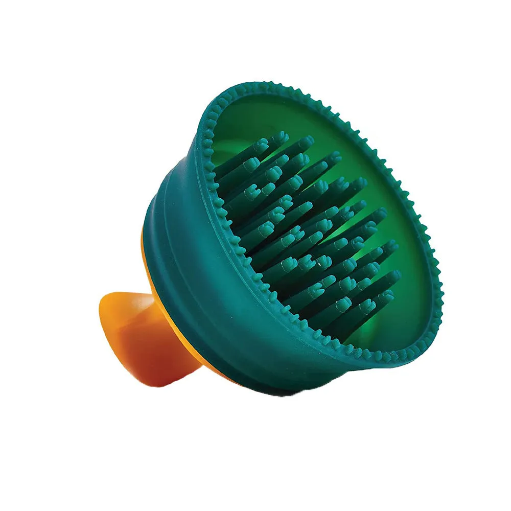 Green double-sided knotted silicone pet hair remover brush on a clean surface