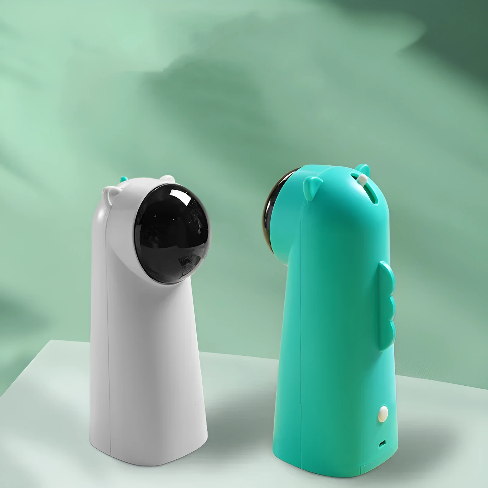 Automatic laser cat pole toy showing green with white plastic housing and LED red laser beam on floor