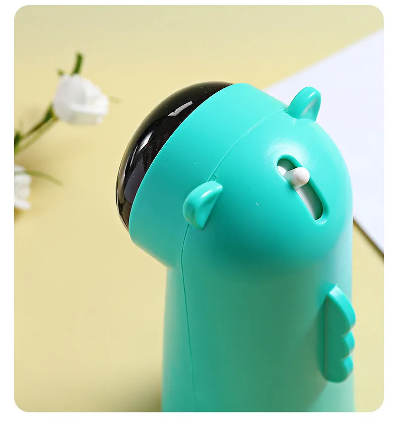 Automatic laser cat pole toy showing green with white plastic housing and LED red laser beam on floor