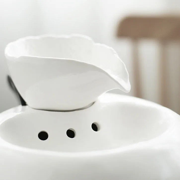 White porcelain leaf-shaped automatic cat water dispenser on floor