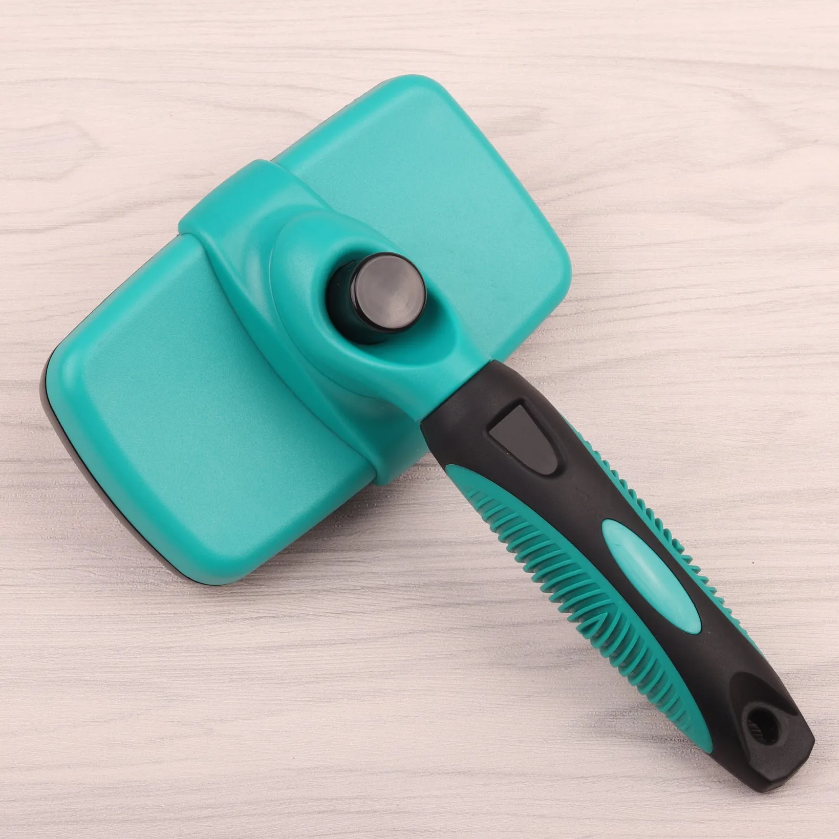 Cat and dog grooming needle comb with stainless steel teeth and dark green ABS TPR handle on white background
