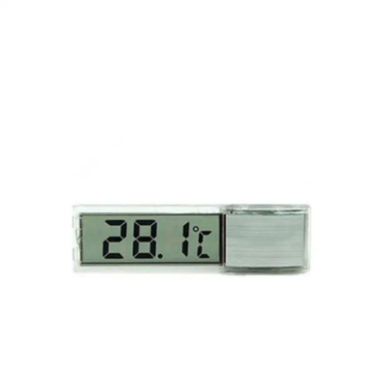 Gold digital thermometer mounted on aquarium glass showing temperature reading