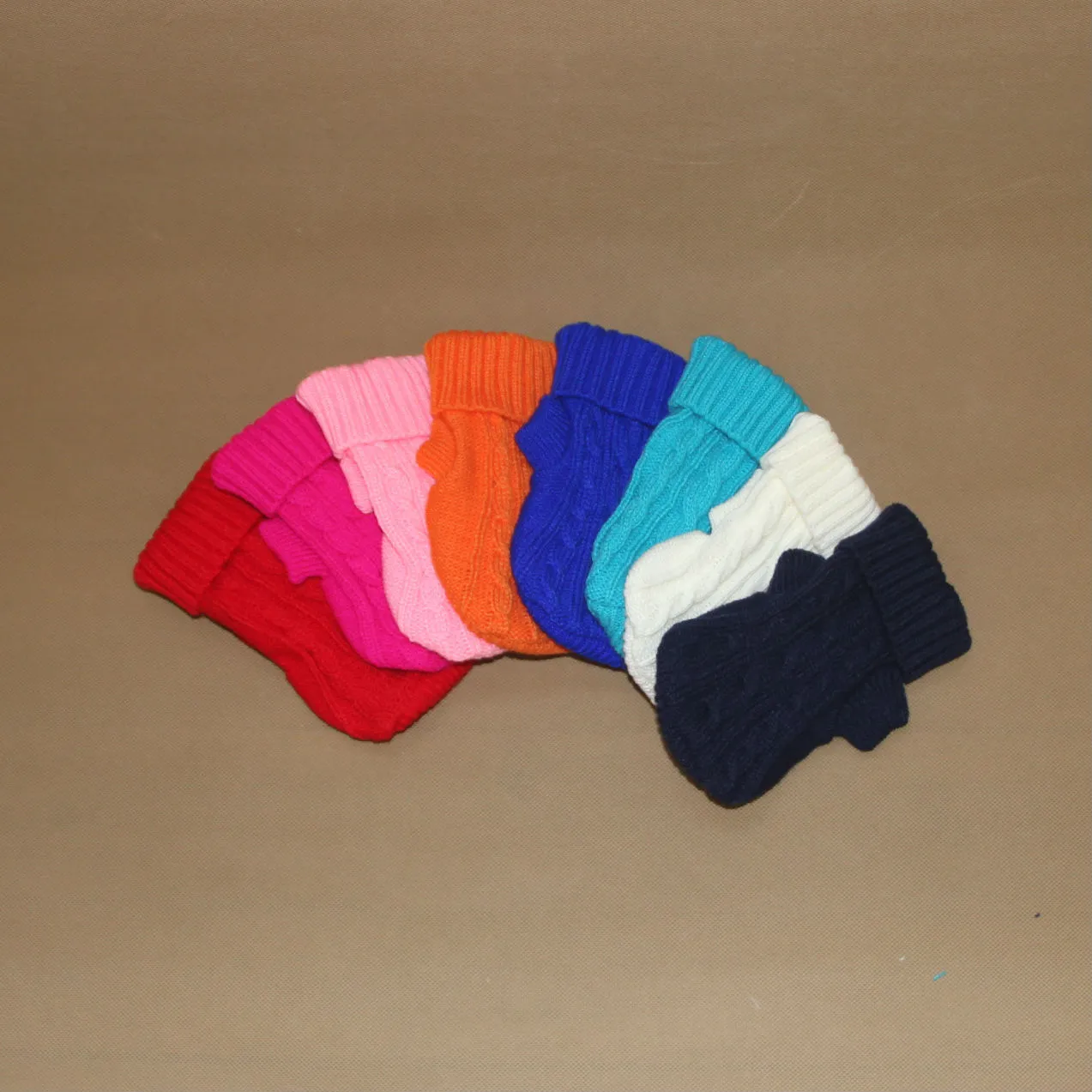 Knitted wool dog sweater with fabric buttons on a white background, shown in blue