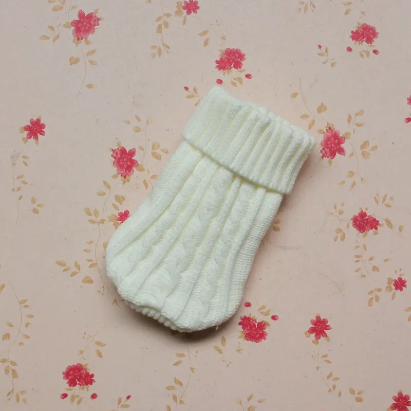Knitted wool dog sweater with fabric buttons on a white background, shown in blue