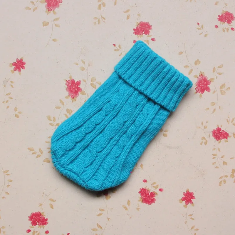 Knitted wool dog sweater with fabric buttons on a white background, shown in blue