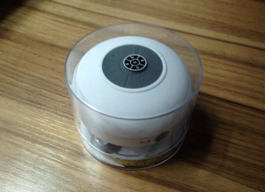 Mini waterproof Bluetooth speaker in blue, compact plastic shell with button controls