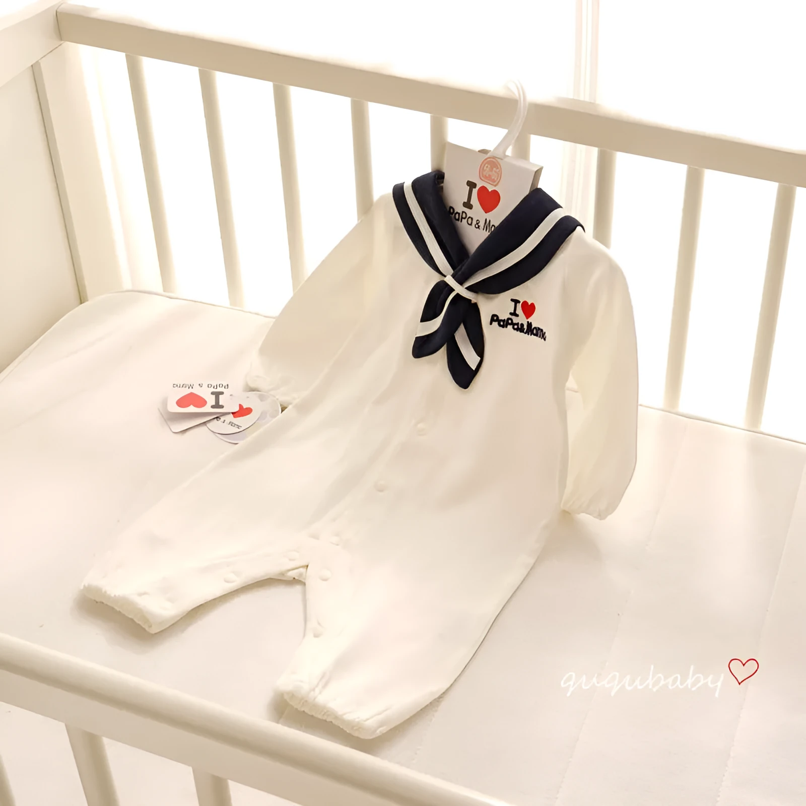 Navy cotton baby onesie with long sleeves and detachable hood on white background