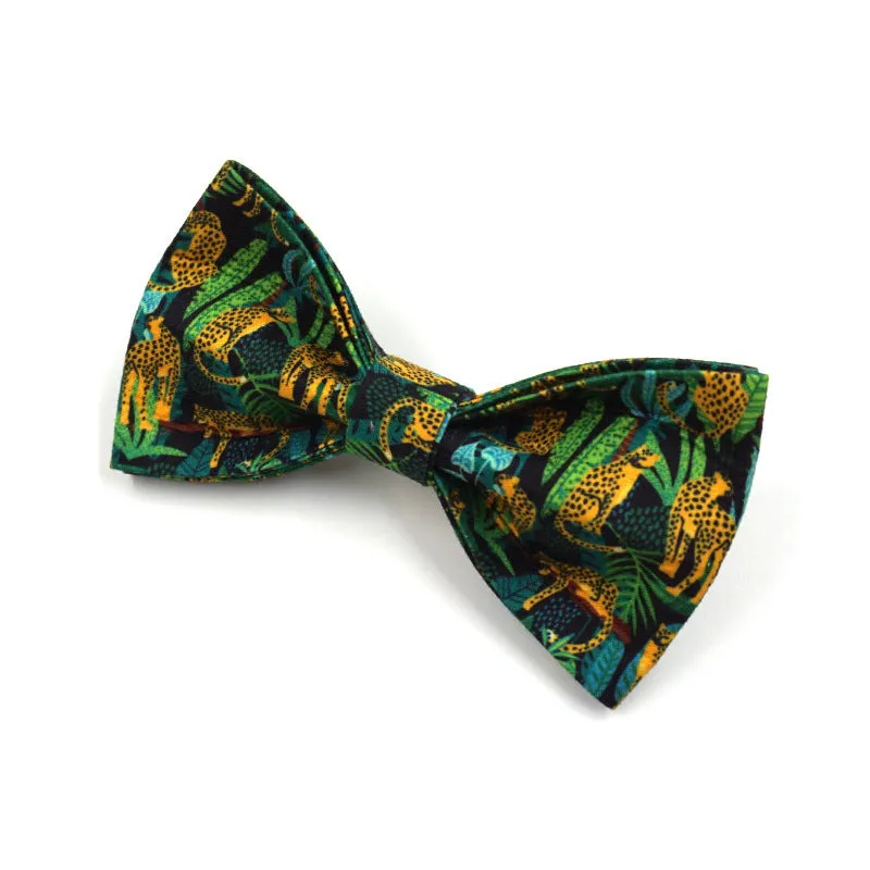 Green cloth pet collar and leash set with bowknot print on a white background showing collar and leash together