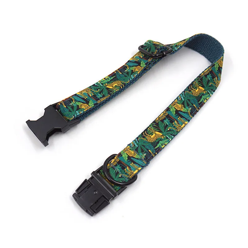 Green cloth pet collar and leash set with bowknot print on a white background showing collar and leash together