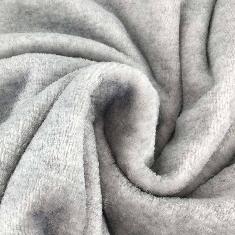 Grey flannel dog blanket 70 by 100 centimetres on a soft surface