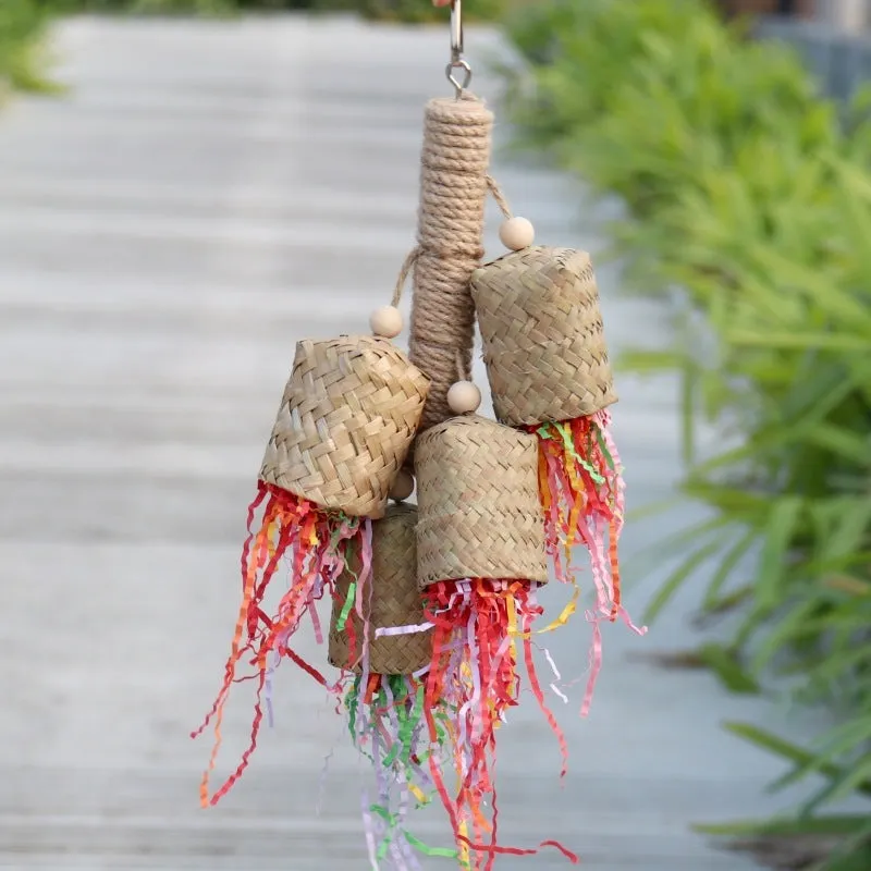 A parrot toy made of wood and sisal rope with colourful shredded paper attachments.