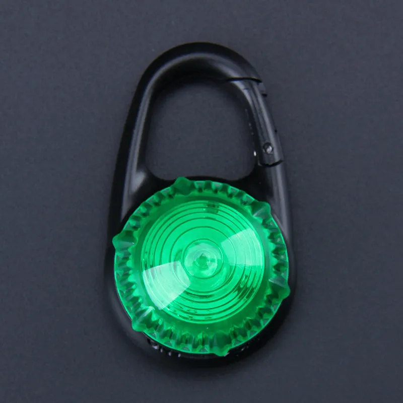 Pink LED flashing pet safety pendant clipped onto a collar with CR2032 batteries, showing 57x33mm ABS water-resistant build